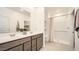 Bright bathroom features double sinks, a large mirror, and a walk-in shower for a luxurious feel at 9530 W Avalon Dr, Phoenix, AZ 85037