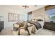 A cozy bedroom featuring neutral tones, an accent wall, and an abundance of natural light with accent chairs at 9530 W Avalon Dr, Phoenix, AZ 85037