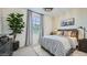 Serene bedroom with natural light, decorative airplane art, and stylish black and white patterned curtains at 9530 W Avalon Dr, Phoenix, AZ 85037