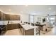 Modern kitchen with quartz countertops and stainless steel appliances open to living area at 9530 W Avalon Dr, Phoenix, AZ 85037