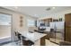 Modern kitchen with a large countertop island, stainless steel appliances, and a seamless flow to the outdoor space at 9530 W Avalon Dr, Phoenix, AZ 85037