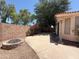 Backyard view with a fire pit, mature trees, and a concrete patio at 1020 W Sunward Dr, Gilbert, AZ 85233