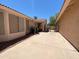 View of the backyard with a concrete patio and black iron fencing at 1020 W Sunward Dr, Gilbert, AZ 85233
