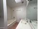 Bright bathroom with a large mirror, shower-tub combo, and natural light from a skylight at 1020 W Sunward Dr, Gilbert, AZ 85233