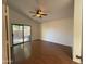Cozy bedroom with hardwood floors, ceiling fan, and a sliding glass door providing access to the backyard at 1020 W Sunward Dr, Gilbert, AZ 85233