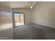 Bedroom with a ceiling fan and access to a patio through sliding glass doors at 1020 W Sunward Dr, Gilbert, AZ 85233