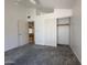 Bedroom with neutral carpet, white walls, ceiling fan and closet with sliding doors at 1020 W Sunward Dr, Gilbert, AZ 85233