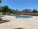 Community pool offers clear blue water and ample lounge seating in a tranquil setting, surrounded by desert landscaping at 1020 W Sunward Dr, Gilbert, AZ 85233