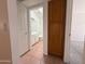 Hallway view into a bathroom with neutral tile flooring at 1020 W Sunward Dr, Gilbert, AZ 85233