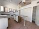 Efficient kitchen with an island, tile flooring, white cabinetry, and plenty of counter space for cooking at 1020 W Sunward Dr, Gilbert, AZ 85233