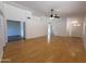 Bright living room featuring hardwood floors, neutral walls, ceiling fan, and entryways to other rooms at 1020 W Sunward Dr, Gilbert, AZ 85233