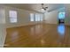 Spacious living room with hardwood floors, ceiling fan, and large windows allowing for plenty of natural light at 1020 W Sunward Dr, Gilbert, AZ 85233