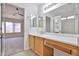 Bathroom with vanity, leading into an adjacent bedroom at 11626 W Holly St, Avondale, AZ 85392