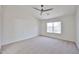 Bright bedroom features neutral carpet, white walls, vaulted ceiling and a ceiling fan at 11626 W Holly St, Avondale, AZ 85392