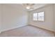 Bright bedroom features neutral carpet, white walls, and a ceiling fan at 11626 W Holly St, Avondale, AZ 85392