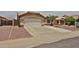 Single Gathering home with desert landscaping, an attached two car garage and a tile roof at 11626 W Holly St, Avondale, AZ 85392