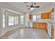 Eat-in kitchen with white appliances, wood cabinets, and large windows overlooking the backyard at 11626 W Holly St, Avondale, AZ 85392