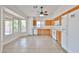 Eat-in kitchen with white appliances, wood cabinets, and large windows overlooking the backyard at 11626 W Holly St, Avondale, AZ 85392