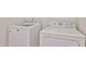 White laundry machines sit in a well lit laundry area at 11626 W Holly St, Avondale, AZ 85392
