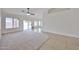 Open concept living room featuring neutral tones and a sliding door to the backyard at 11626 W Holly St, Avondale, AZ 85392