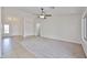 Bright living room featuring neutral tones, tile and carpet flooring, and a ceiling fan at 11626 W Holly St, Avondale, AZ 85392