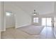 Bright living room featuring neutral tones, tile and carpet flooring, and a ceiling fan at 11626 W Holly St, Avondale, AZ 85392