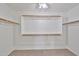 Empty walk-in closet with white walls and built-in shelving at 11626 W Holly St, Avondale, AZ 85392