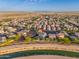 Expansive aerial view of a suburban neighborhood, showcasing the home's location and community amenities at 12110 W Rowel Rd, Peoria, AZ 85383