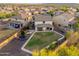 Large, grassy backyard with a covered patio, offering ample space for outdoor activities at 12110 W Rowel Rd, Peoria, AZ 85383