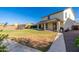 Spacious backyard with a covered patio, lush lawn, and mature landscaping, ideal for entertaining and outdoor living at 12110 W Rowel Rd, Peoria, AZ 85383