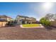 Expansive backyard featuring a grassy area, a trampoline, and plenty of space for outdoor activities and entertaining at 12110 W Rowel Rd, Peoria, AZ 85383