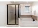 Bathroom featuring a glass shower and soaking tub at 12110 W Rowel Rd, Peoria, AZ 85383
