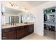 Bathroom with double sinks and a walk-in closet at 12110 W Rowel Rd, Peoria, AZ 85383