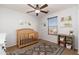 Bright bedroom with crib, rug and decor shelves at 12110 W Rowel Rd, Peoria, AZ 85383