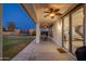 Spacious covered patio with a ceiling fan, perfect for outdoor dining and entertaining, overlooking the lawn at 12110 W Rowel Rd, Peoria, AZ 85383