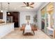 Cozy dining area features a wood table, backyard access, and a stainless steel refrigerator at 12110 W Rowel Rd, Peoria, AZ 85383