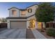 Charming two-story home featuring a well-manicured lawn, two car garage and tile roof at 12110 W Rowel Rd, Peoria, AZ 85383
