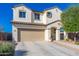 Charming two-story home featuring a well-manicured lawn, two car garage and tile roof at 12110 W Rowel Rd, Peoria, AZ 85383