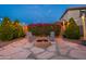 Cozy fire pit area with comfortable chairs, decorative plants, and string lights at 12110 W Rowel Rd, Peoria, AZ 85383
