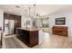 Beautiful kitchen island with granite counters and bar seating next to stainless appliances at 12110 W Rowel Rd, Peoria, AZ 85383