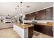 Open-concept kitchen featuring a granite island, stainless steel appliances, and stylish cabinets at 12110 W Rowel Rd, Peoria, AZ 85383