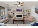 Spacious living room with built-in bookshelves, a fireplace, and comfortable seating at 12110 W Rowel Rd, Peoria, AZ 85383