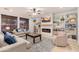 Bright living room with a fireplace, custom built-in shelving, and large windows providing ample natural light at 12110 W Rowel Rd, Peoria, AZ 85383