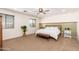 Serene main bedroom featuring carpet floors, neutral walls, and a large window for natural light at 12110 W Rowel Rd, Peoria, AZ 85383