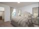 Comfortable bedroom with a large bed, bedside tables, and a walk in closet at 15515 W Deanne Dr, Waddell, AZ 85355