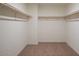 Spacious walk-in closet with ample shelving and rod space for storage at 15515 W Deanne Dr, Waddell, AZ 85355