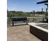 Community park bench surrounded by plants and modern metal shade structures at 15515 W Deanne Dr, Waddell, AZ 85355