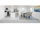 Bright dining area with kitchen island, stylish seating, and a modern open concept at 15515 W Deanne Dr, Waddell, AZ 85355