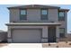 Charming two-story home with a two-car garage and neutral-colored exterior at 15515 W Deanne Dr, Waddell, AZ 85355