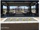 Picnic area with tables beneath a shaded structure with a view of the playground at 15515 W Deanne Dr, Waddell, AZ 85355